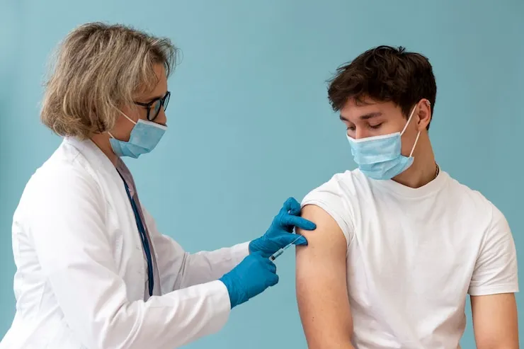 doctor injecting patient
